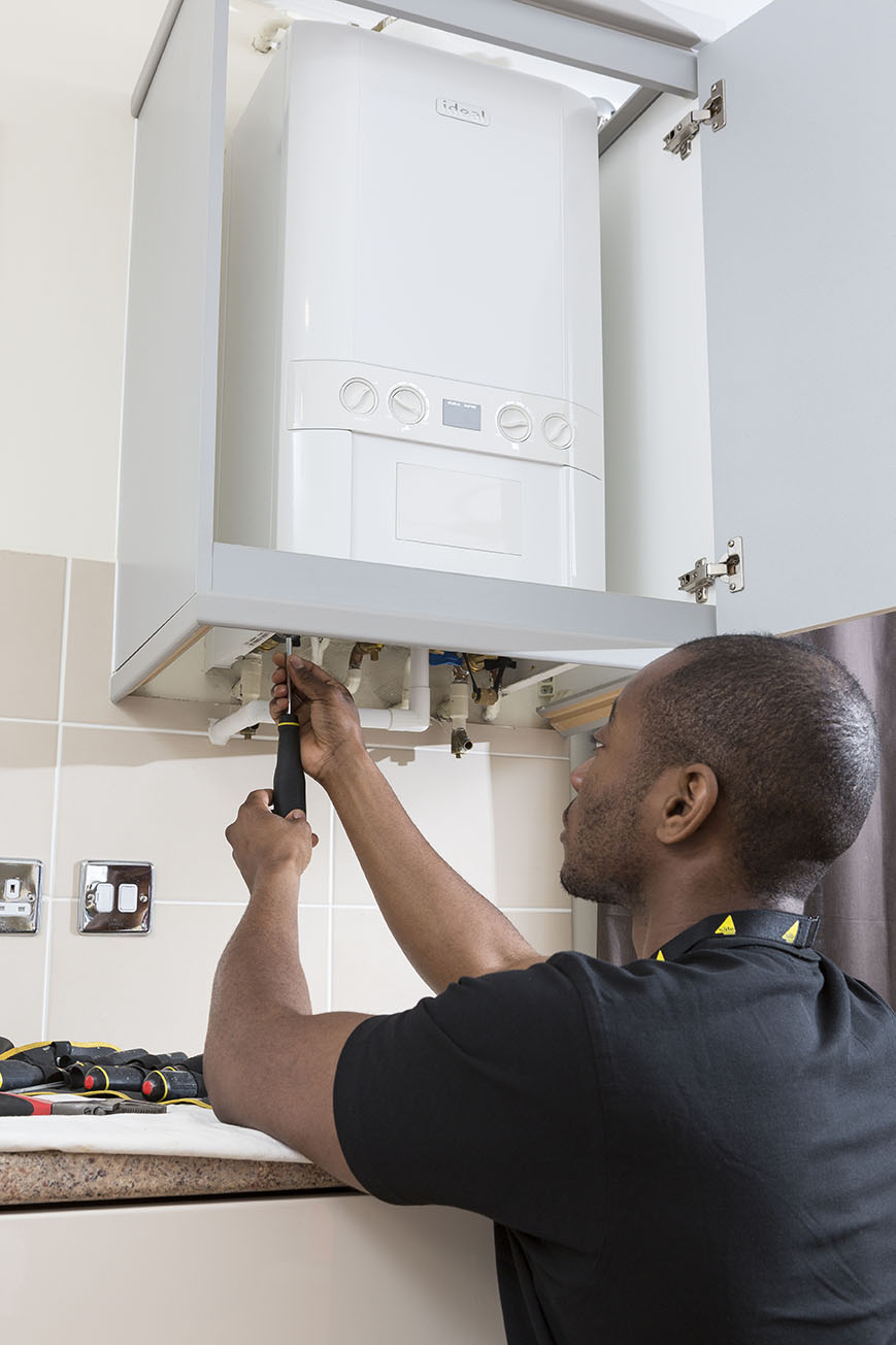 Engineer performing boiler service